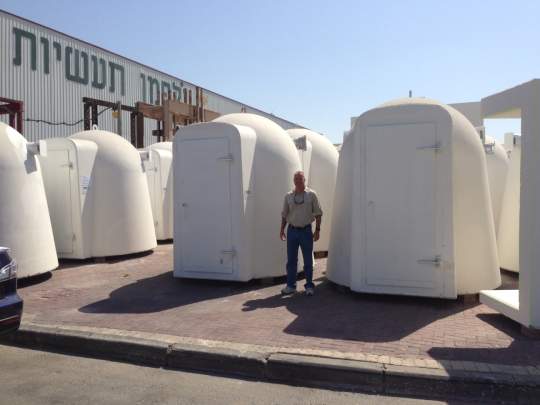 Man standing in front of shelters