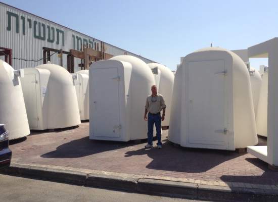 Man standing in front of shelters